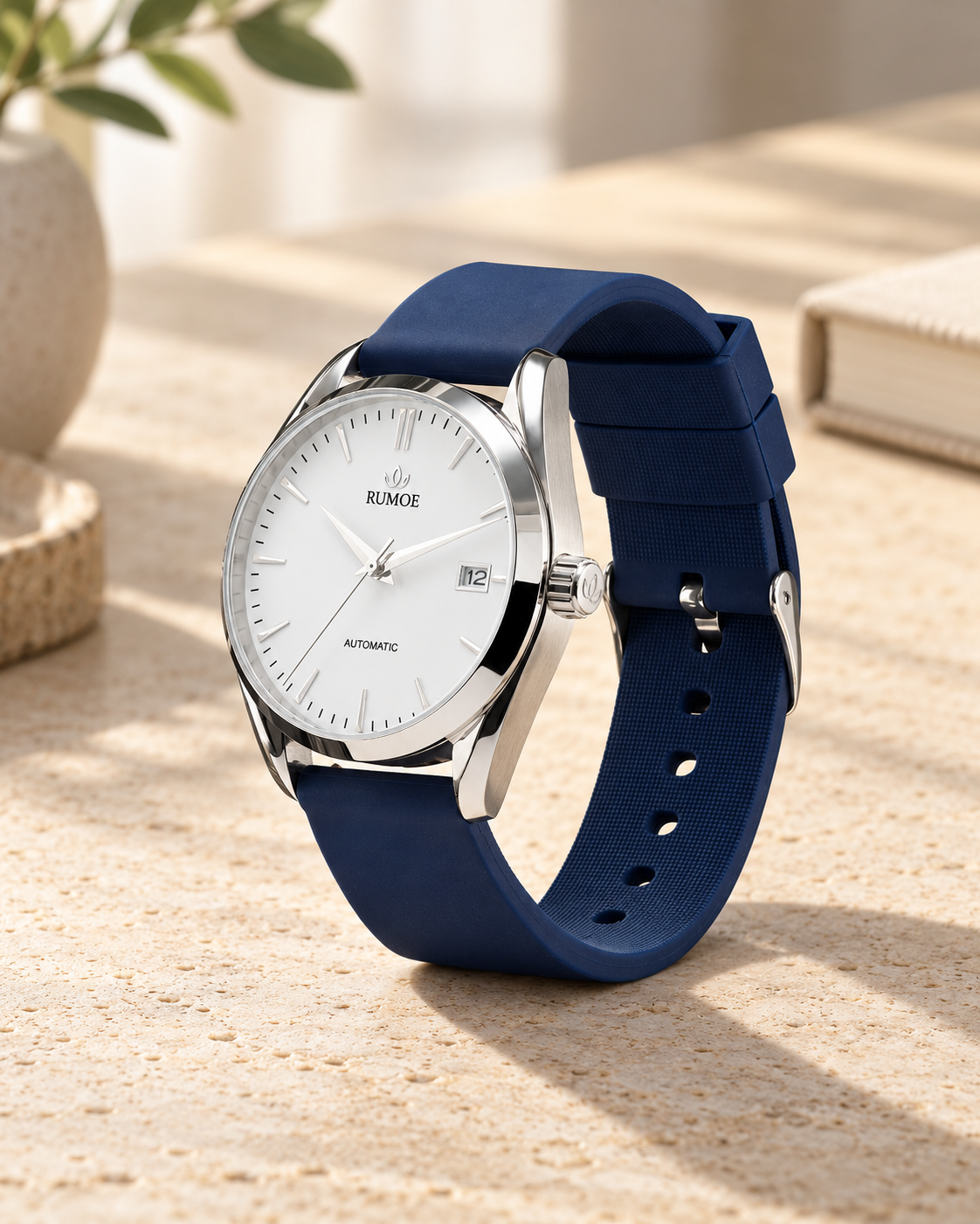 Nobel Royal Rimbo automatic watch with navy rubber strap on a light stone desk